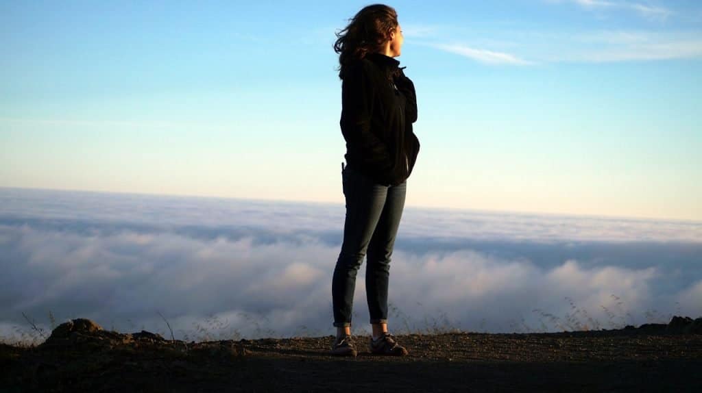 Woman Standing On Mountain