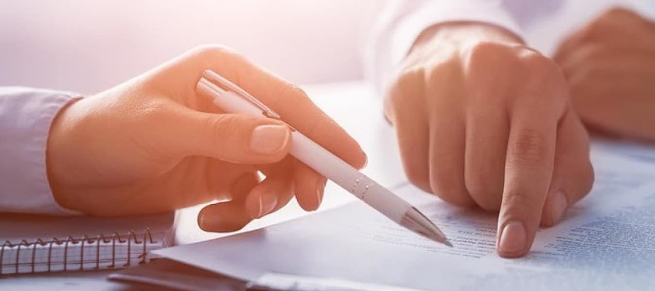 Hands Signing Documents