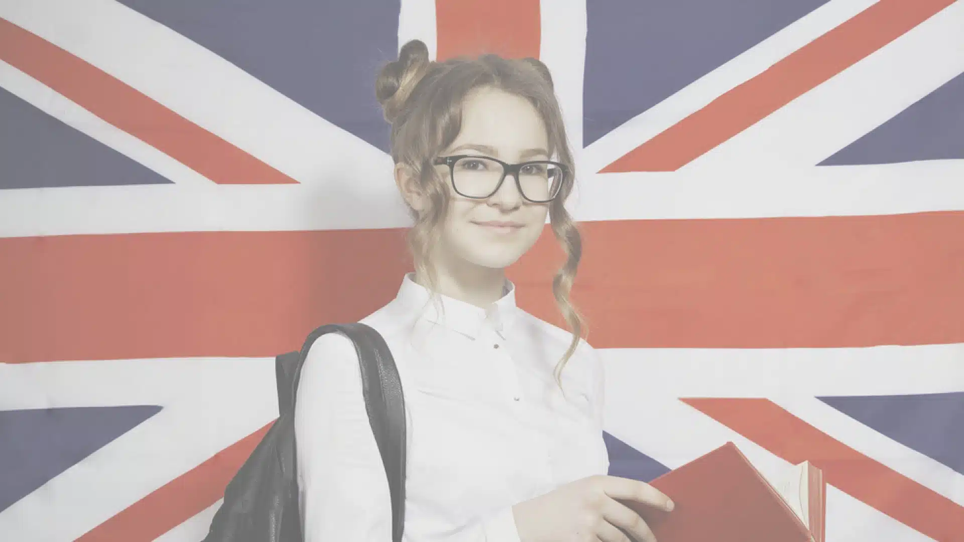 Student Standing Before Union Jack Flag