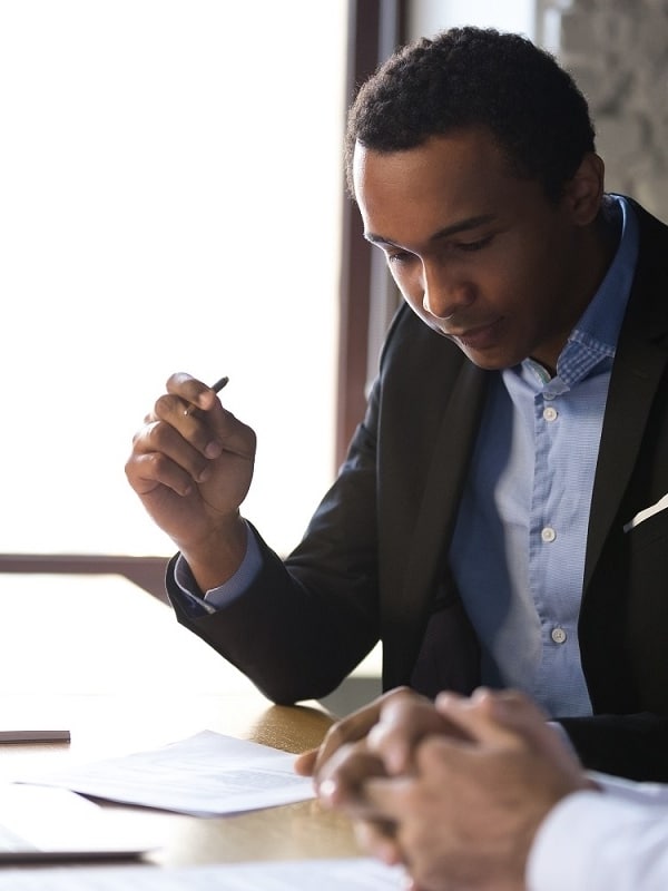 Businessman reading immigration documents at meeting