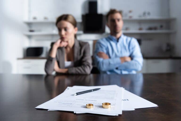 couple sitting at table with divorce documents