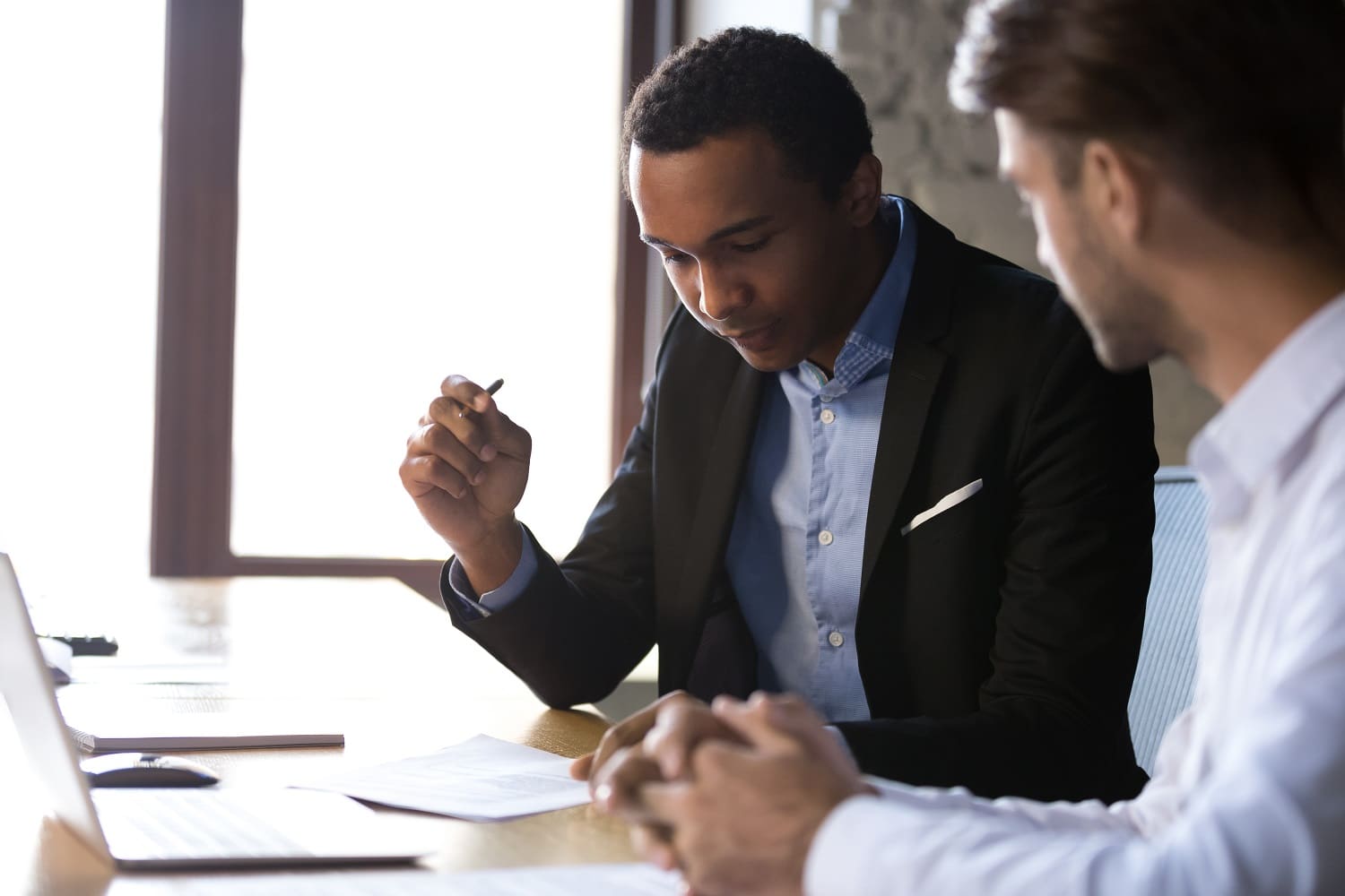 Businessman reading immigration documents at meeting