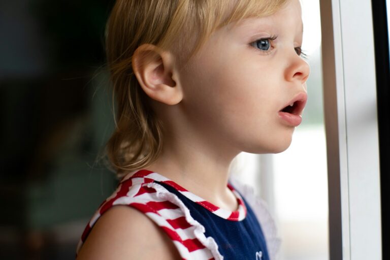 Girl Looking Out Of Window