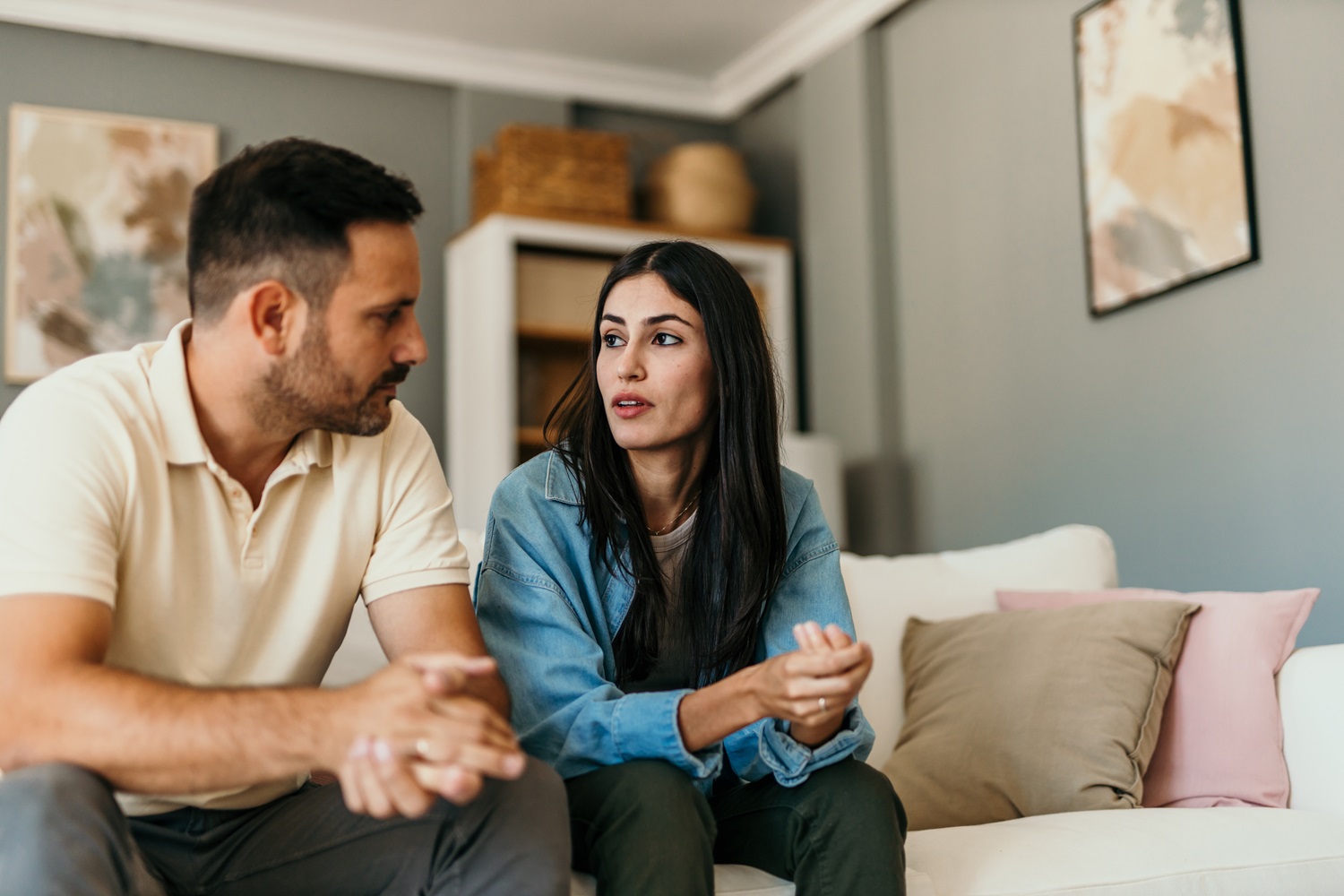 Couple discussing divorce on sofa