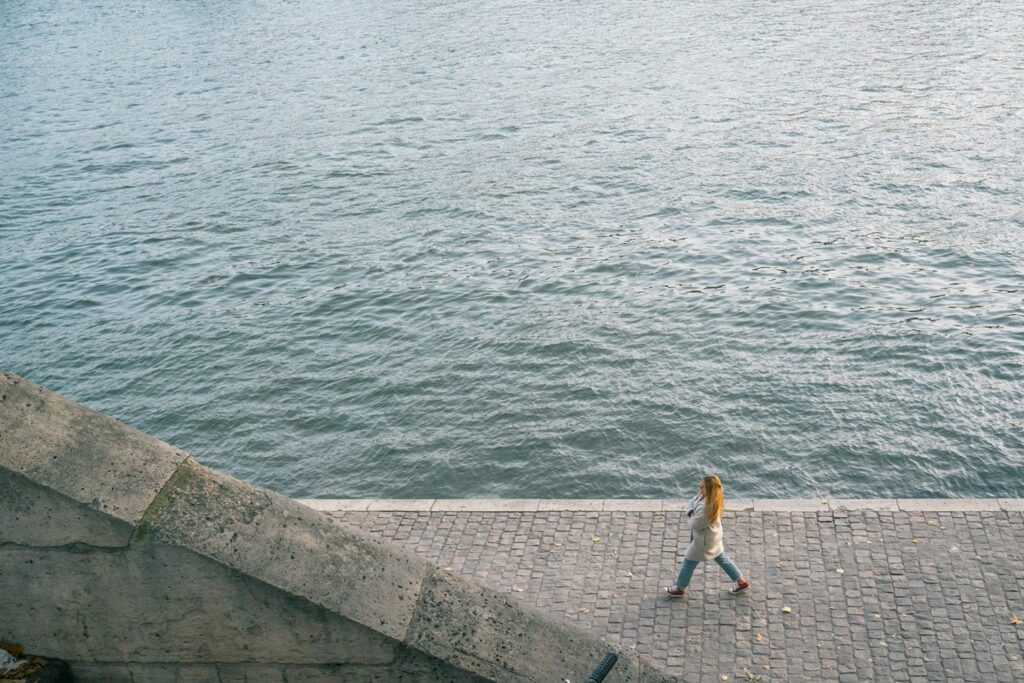 Walking alone beside the Seine