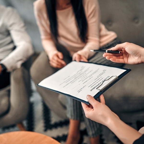 Couple Signing No-Fault Divorce Paperwork
