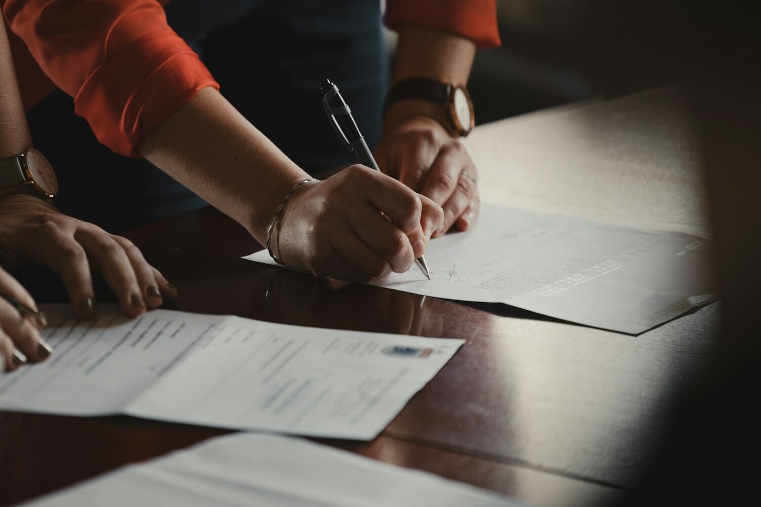 Couple Signing Divorce Settlement Paperwork