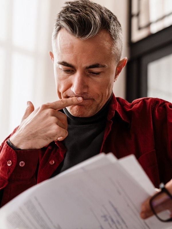 Man Reading Consent Order Document