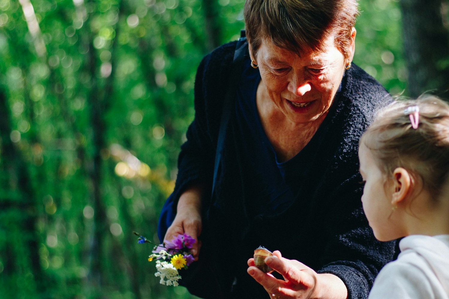 Grandmother Showing Granddaughter Flowers