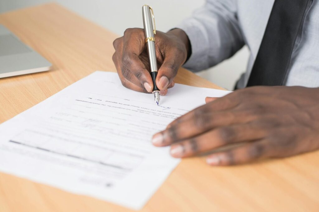 man signing form