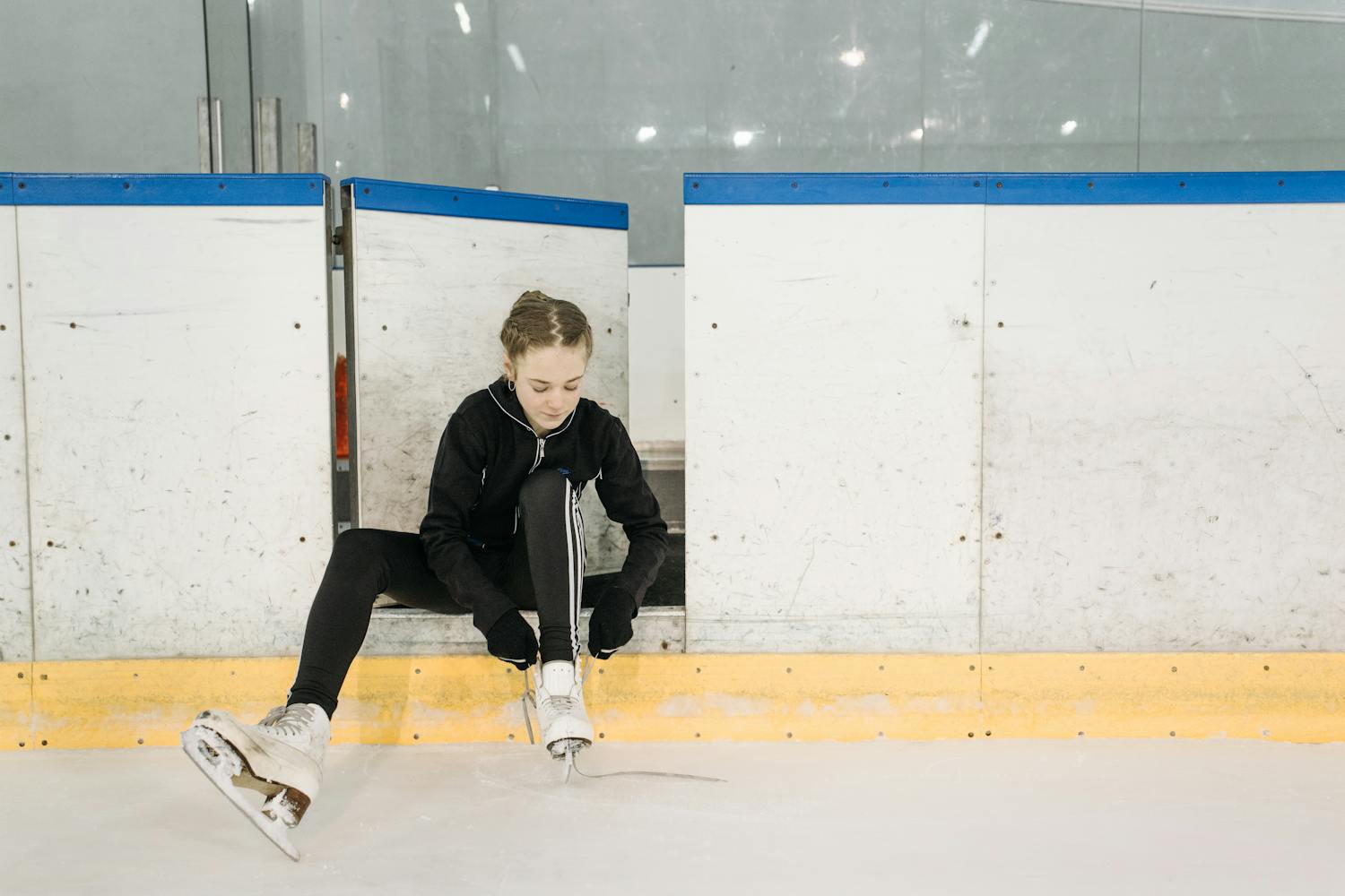 Girl Putting on Ice Skates