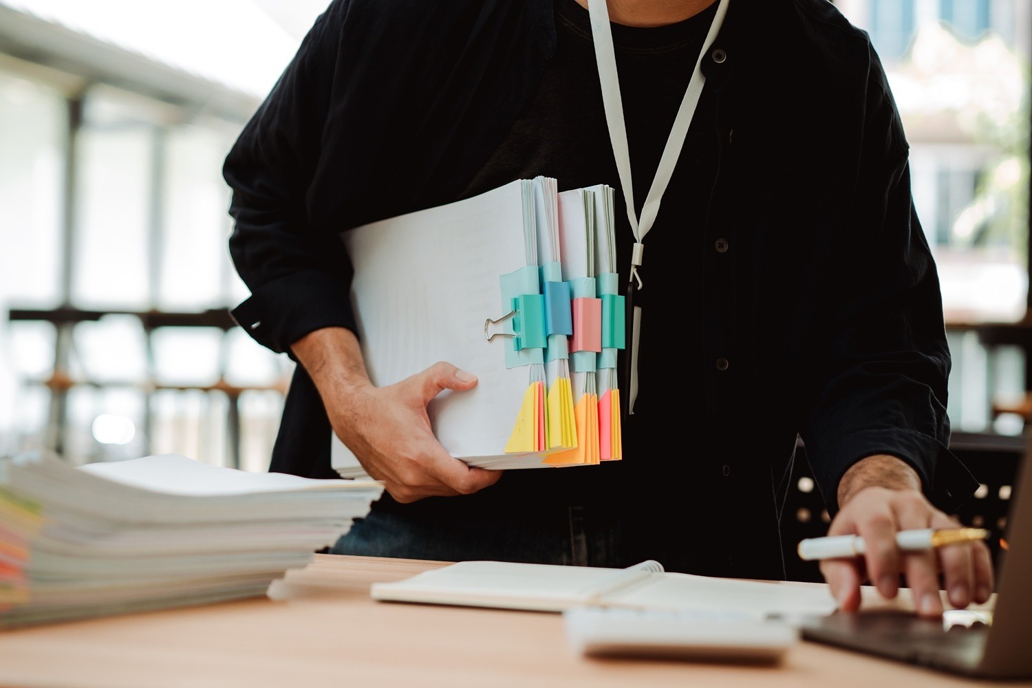 employee working with a large number of documents