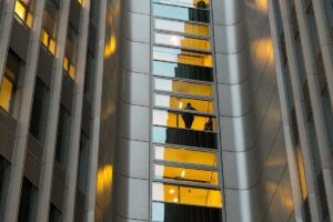 Reflection of a person in a modern building