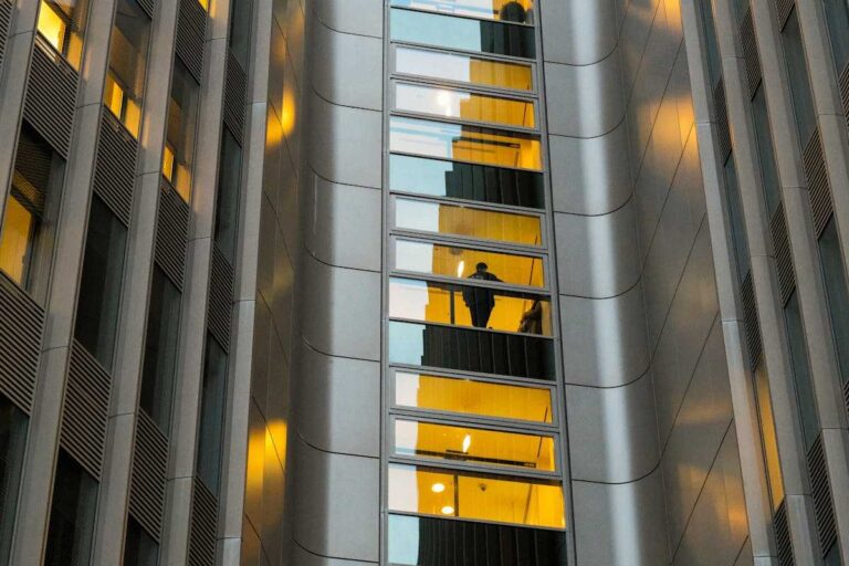 Reflection of a person in a modern building