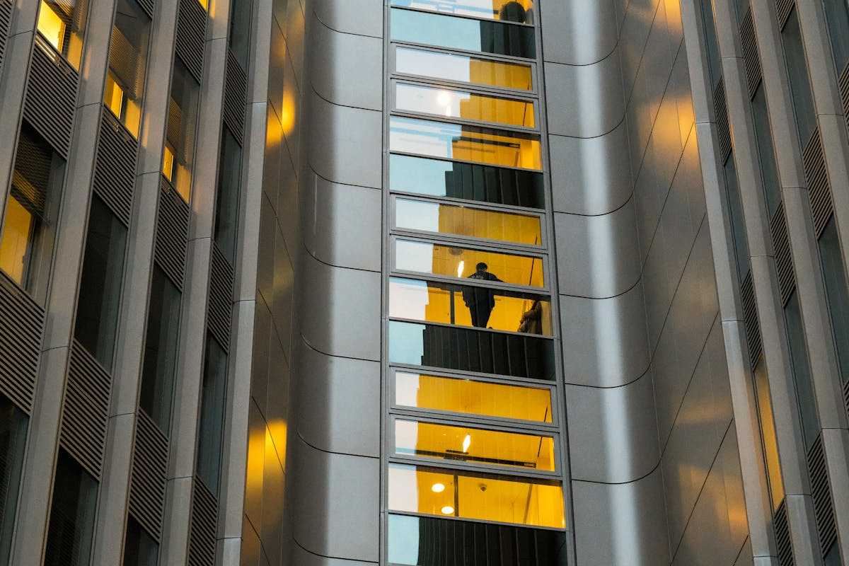 Reflection of a person in a modern building