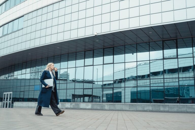 businesswoman walking past commercial building