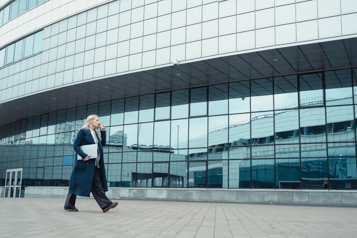 businesswoman walking past commercial building