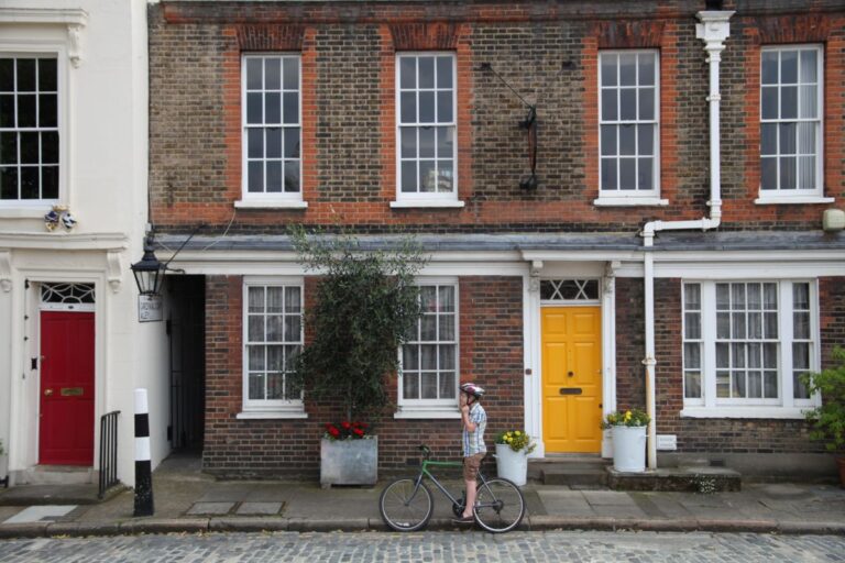 boy on bike outside house in london street