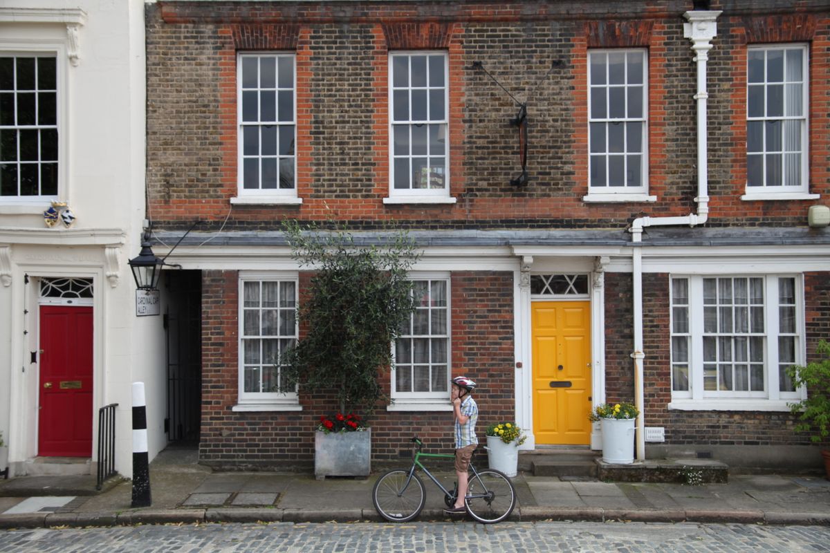 boy on bike outside house in london street