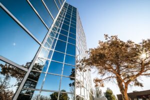 modern glass building reflecting blue sky
