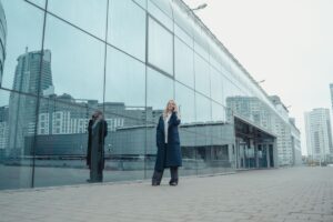 Business woman on phone outside commercial building
