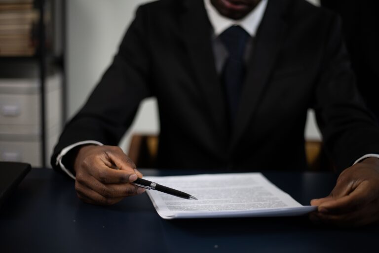 man signing paper