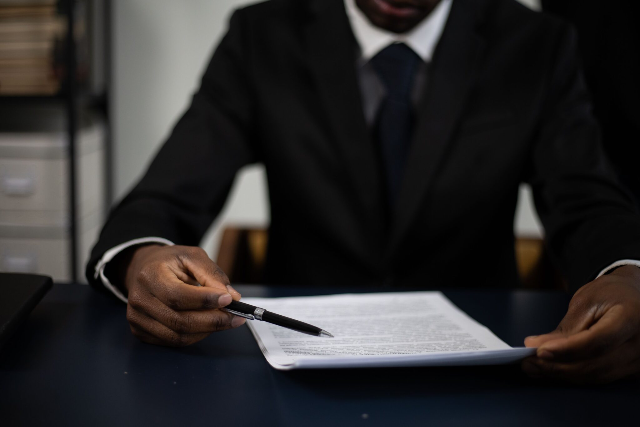 man signing paper