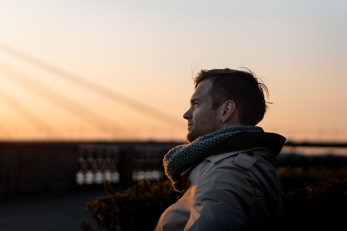 man enjoys a tranquil moment at sunset outdoors