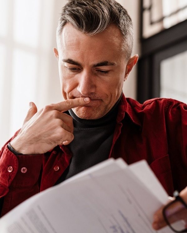 Man Reading Consent Order Document